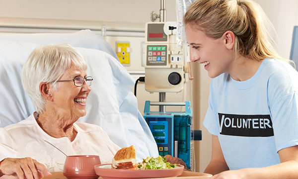 volunteer at patient's bedside